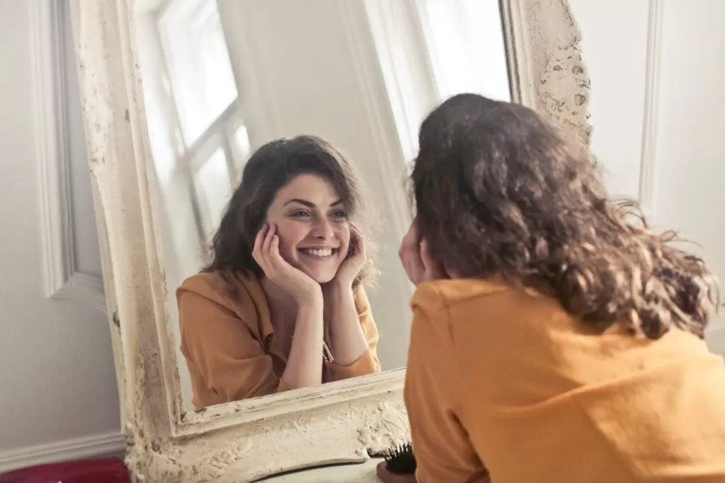 A woman smiling in the mirror 