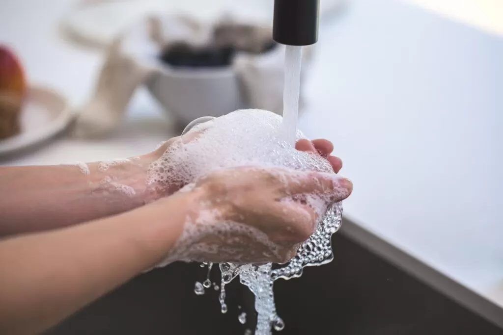 a water running on a hand with foaming soap