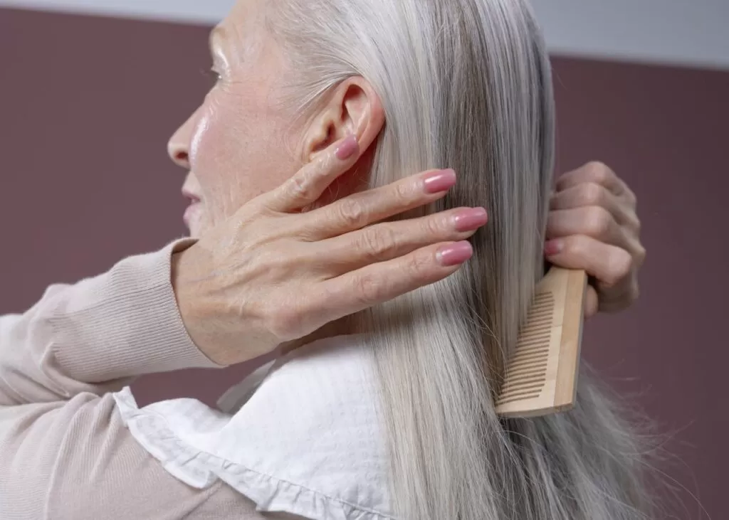 an old woman brushing her hair 