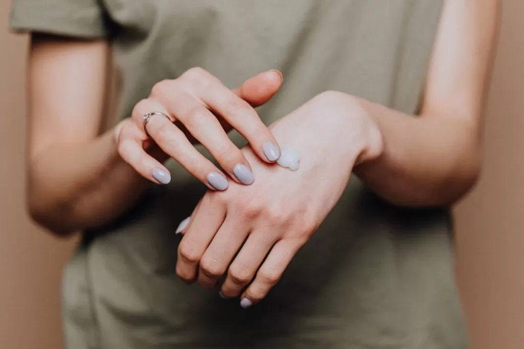 a cleanser on a womans hand 