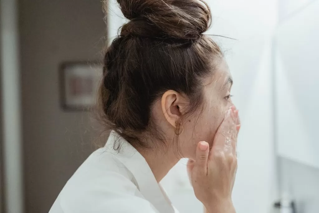a woman washing her face 